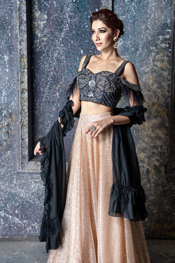 Black & dull silver embroidered cold shoulder blouse with feather detail & gold sequin skirt with feathers & ruffled dupatta