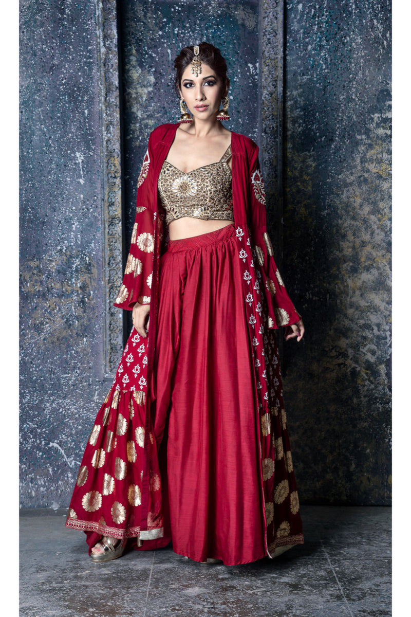 Gold leather applique embroidered blouse with red draped slit skirt & foil printed organza cape with sleeve embroidery